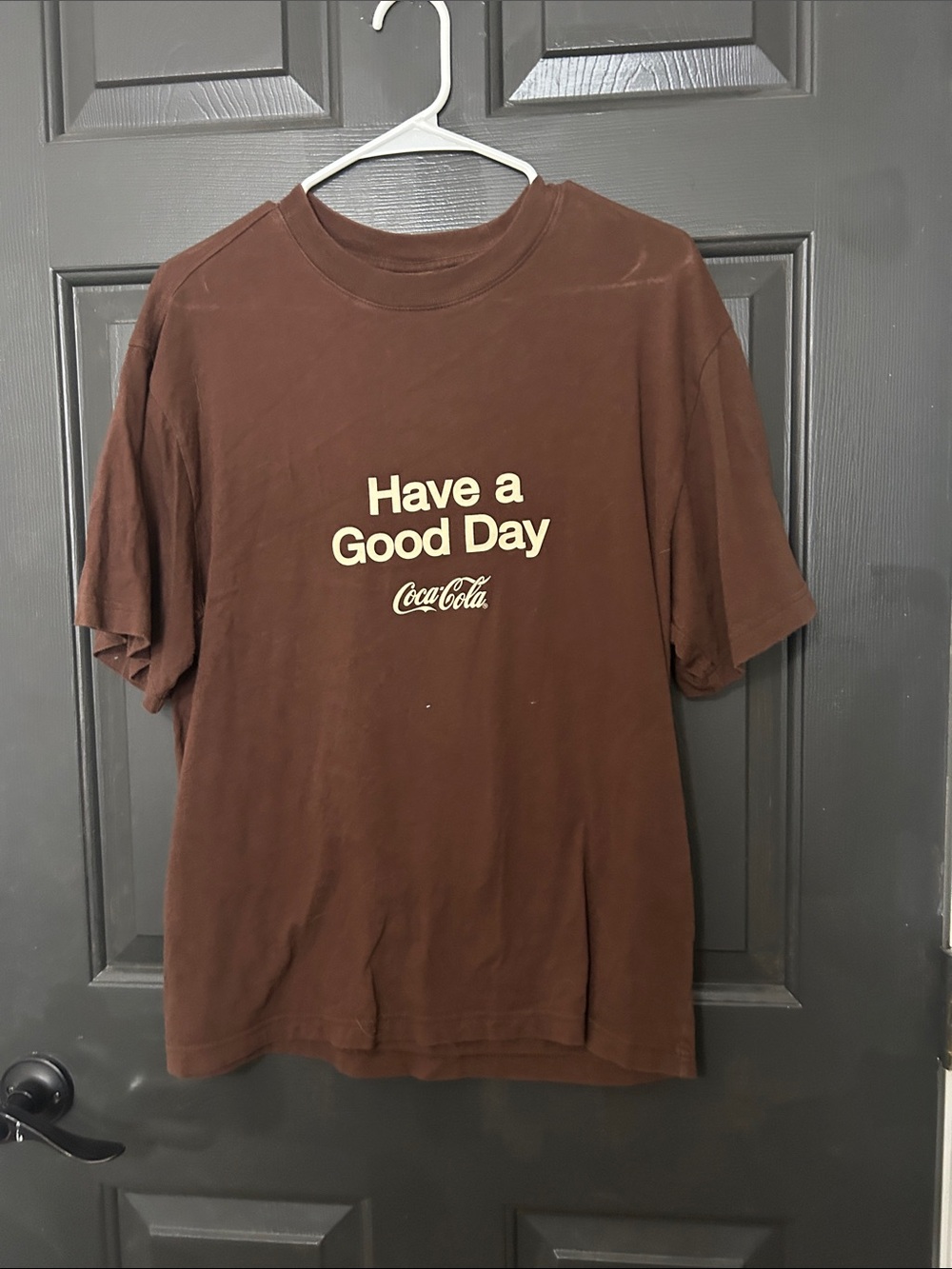 Coca Cola Brown Graphic Tee with Cream 'Have a Good Day' Print